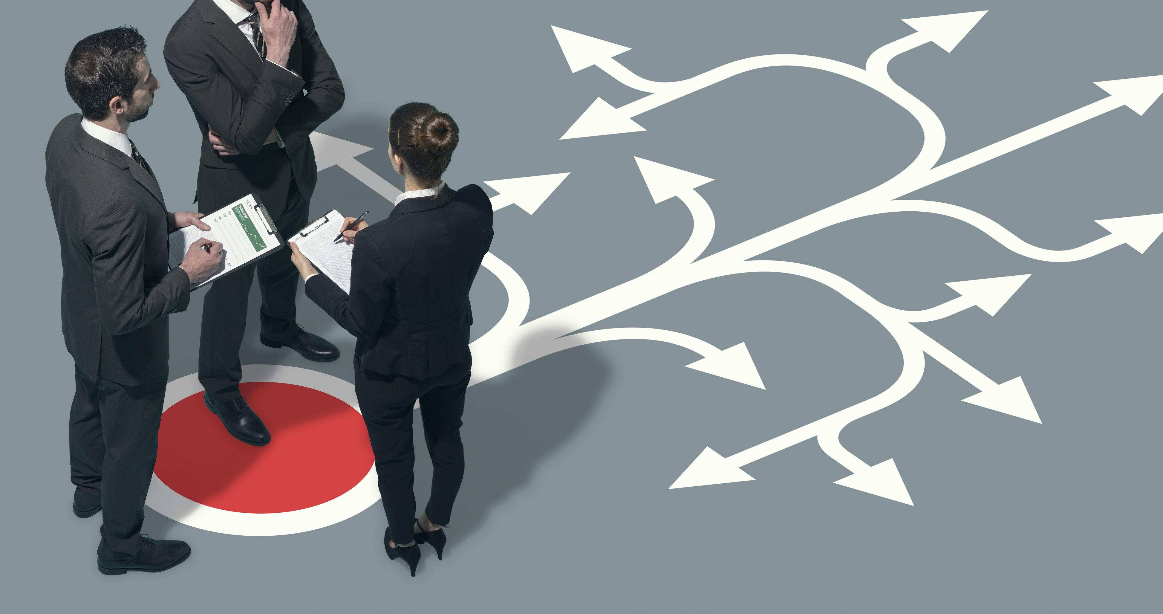 Corporate team planning strategies for their business, they are pondering direction and taking decisions together