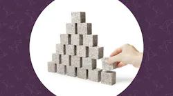 Unstable. Hand removing one block of a pyramid made of small granite rock blocks. Unstable. Hand removing one block of a pyramid made of small granite rock blocks.
