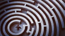 Businessman at the center of a maze Businessman at the center of a maze