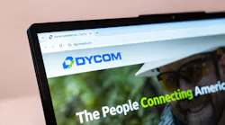 Dycom Industries website on a laptop screen showing telecommunications and infrastructure services