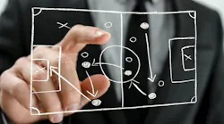 Closeup of pointing to a football strategy plan drawn on a virtual screen.