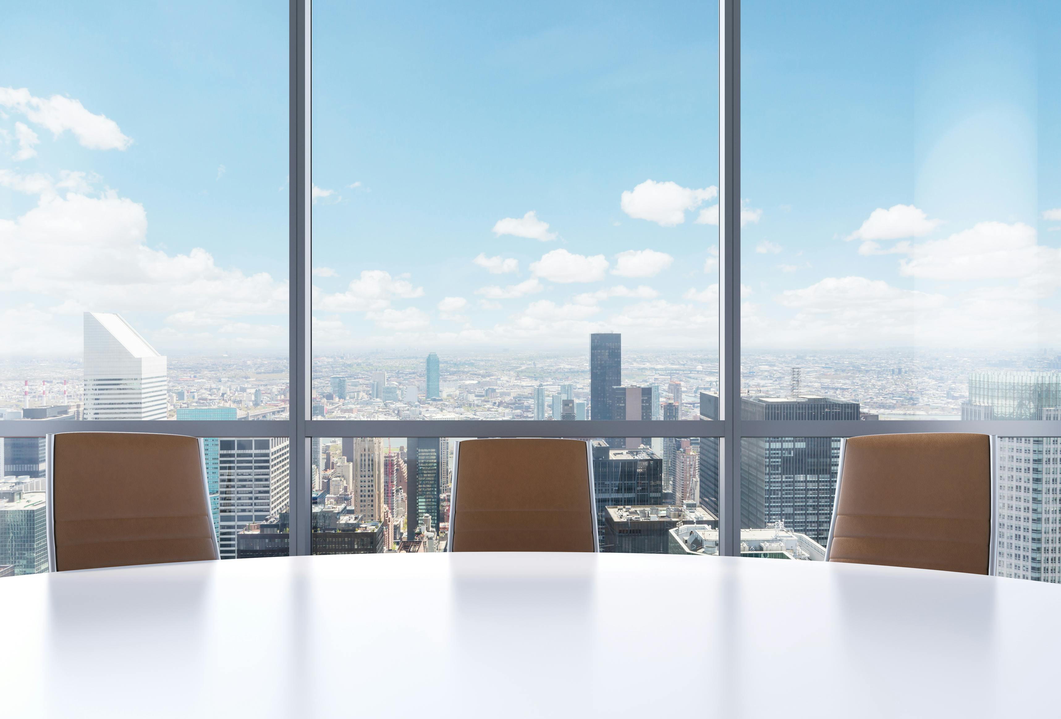 Panoramic conference room in modern office, New York city view from the windows. Close-up of the brown chairs and a white round table. 3D rendering.