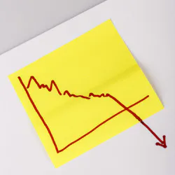 Note paper with finance business graph going down - loss. Close up of a note paper with business graph going down 2 Note paper with finance business graph going down - loss. Close up of a note paper with business graph going down 2