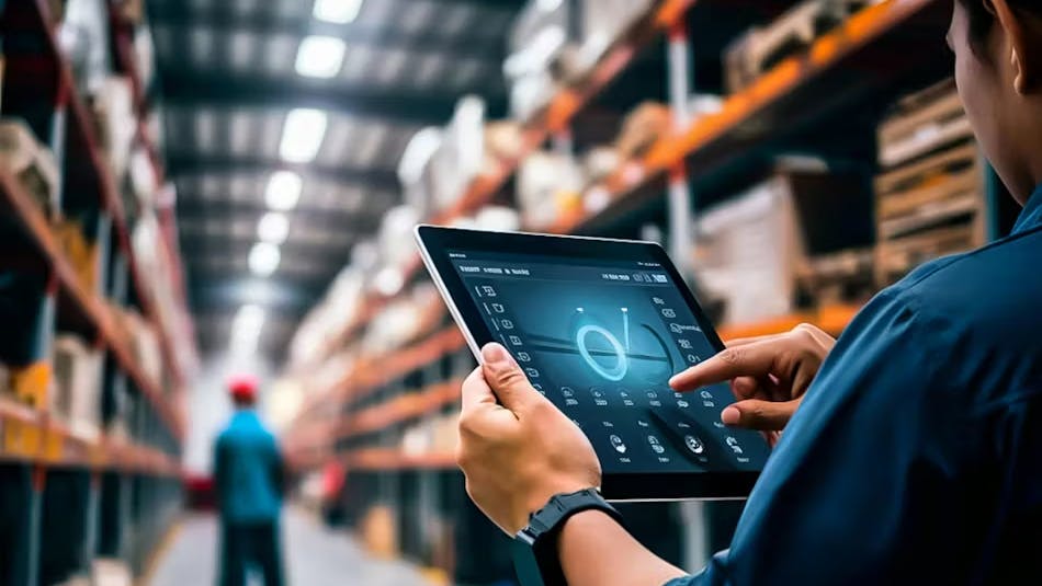 A logistics worker using a tablet in a warehouse.