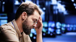 A male engineer struggles in a data center. A male engineer struggles in a data center.