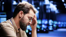 A male engineer struggles in a data center.
