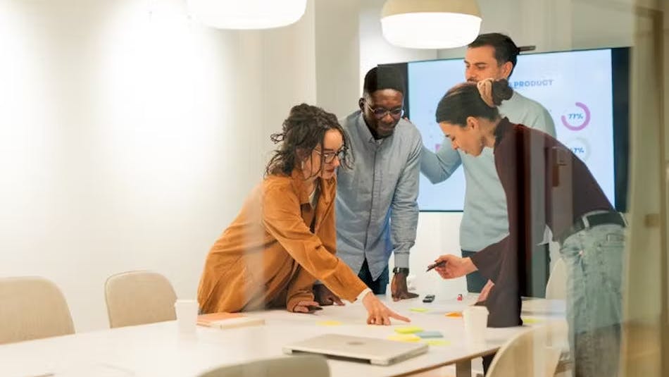 A team of young men and women in a meeting room.