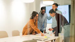 A team of young men and women in a meeting room.