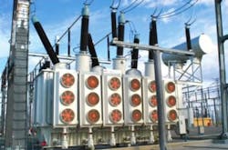 Image of an industrial transformer with blue sky in the background. Image of an industrial transformer with blue sky in the background.