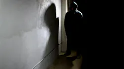 Silhouette of scary hooded criminal in the shadows. Silhouette of scary hooded criminal in the shadows.