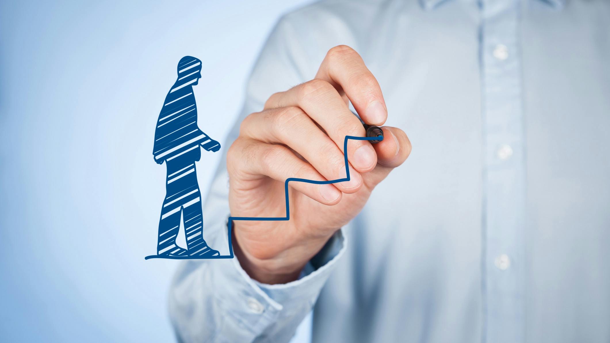 A man drawing a virtual man walking up virtual stairs, representing progress.