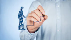 A man drawing a virtual man walking up virtual stairs, representing progress. A man drawing a virtual man walking up virtual stairs, representing progress.