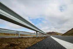Steel guard rail barrier on the motorway without reflective sign Steel guard rail barrier on the motorway without reflective sign