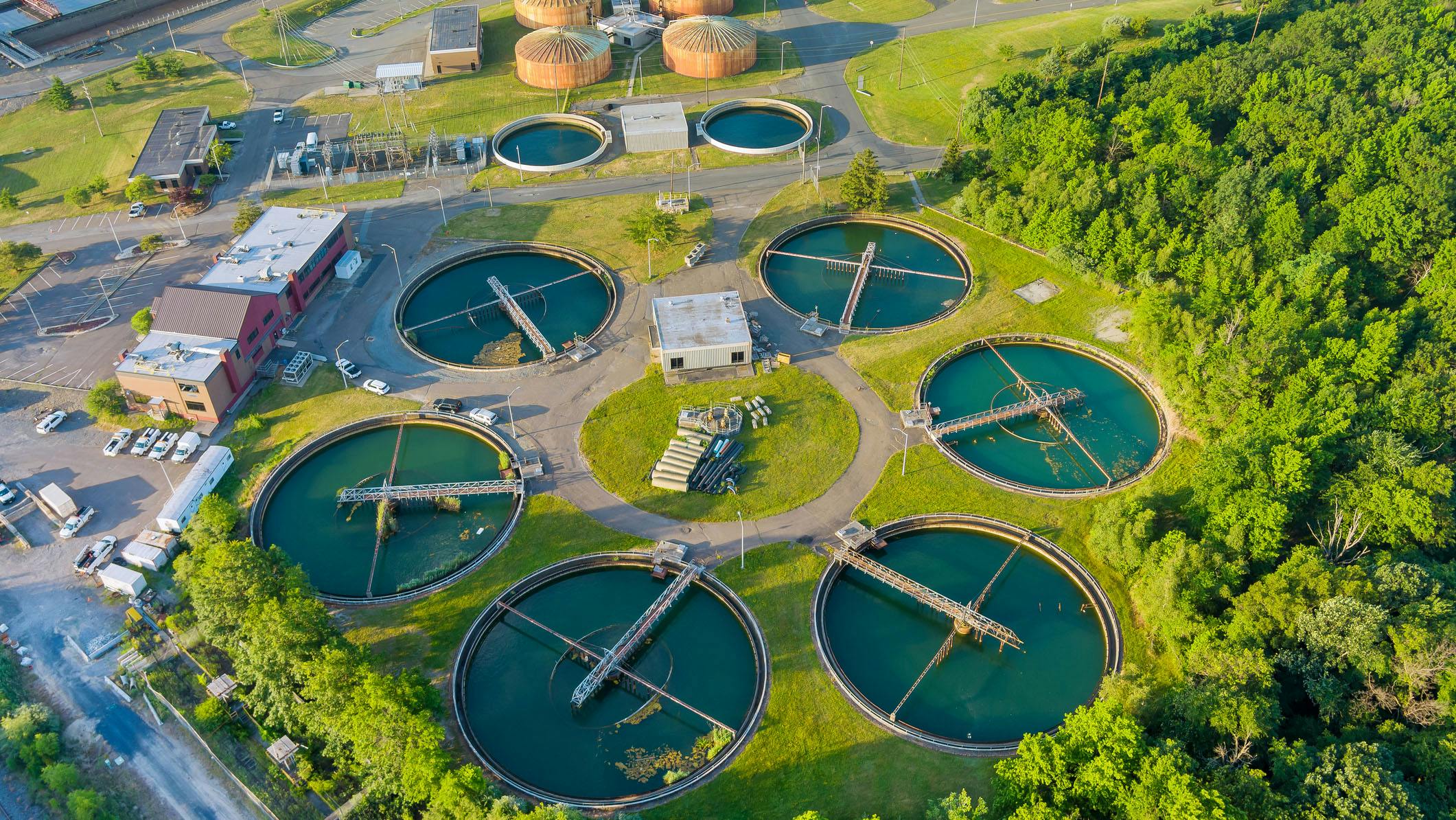 Aerial top view of a city wastewater treatment plant with recirculation sediment tanks.
