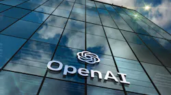 OpenAI glass building San Franciso headquarters with logo and clouds reflected on the windows.