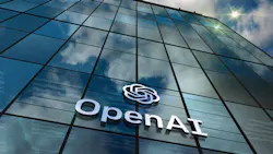 OpenAI glass building San Franciso headquarters with logo and clouds reflected on the windows.