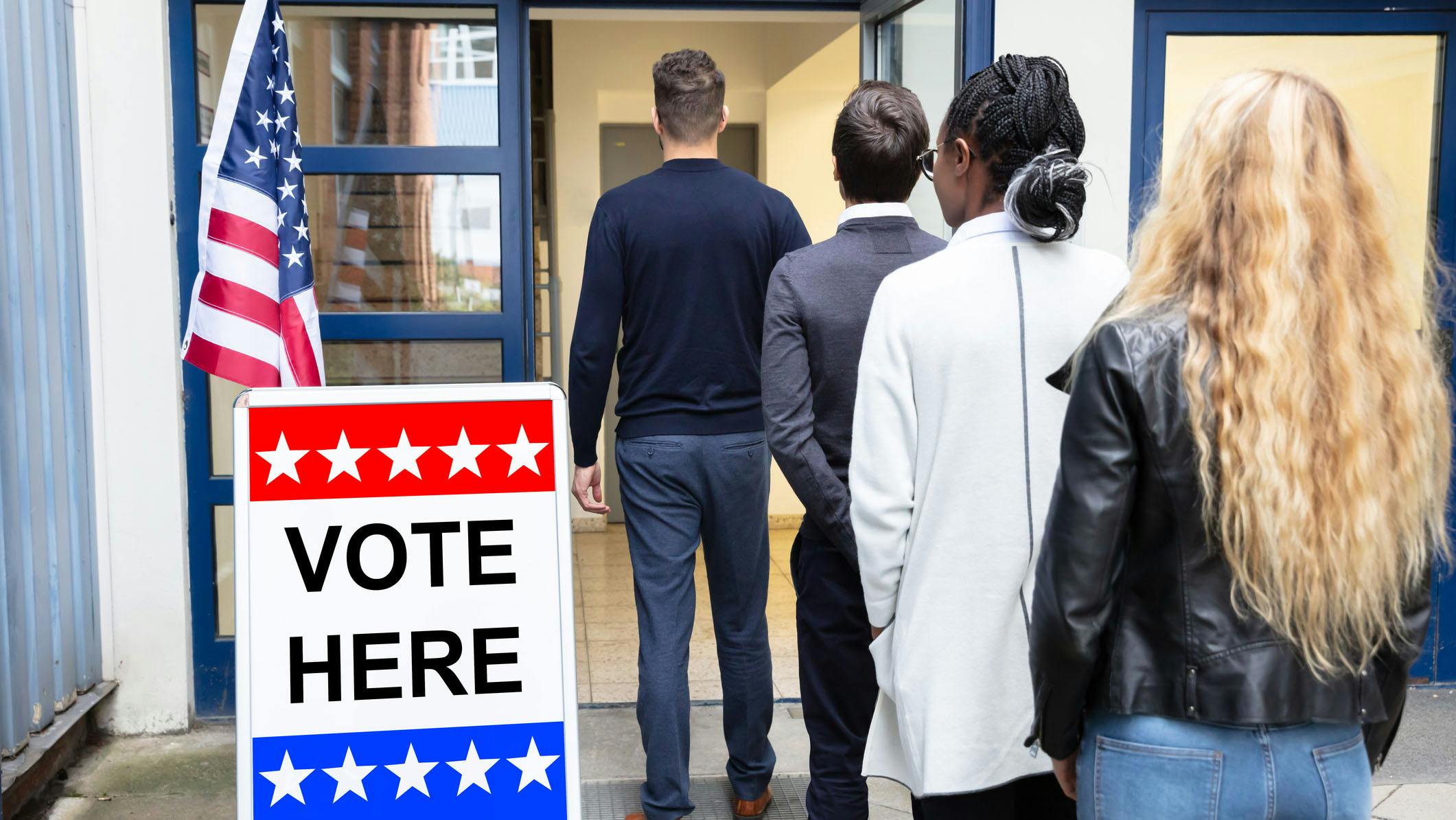 People standing in line outside a voting polling place.