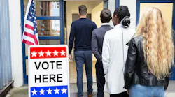People standing in line outside a voting polling place.