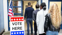People standing in line outside a voting polling place.