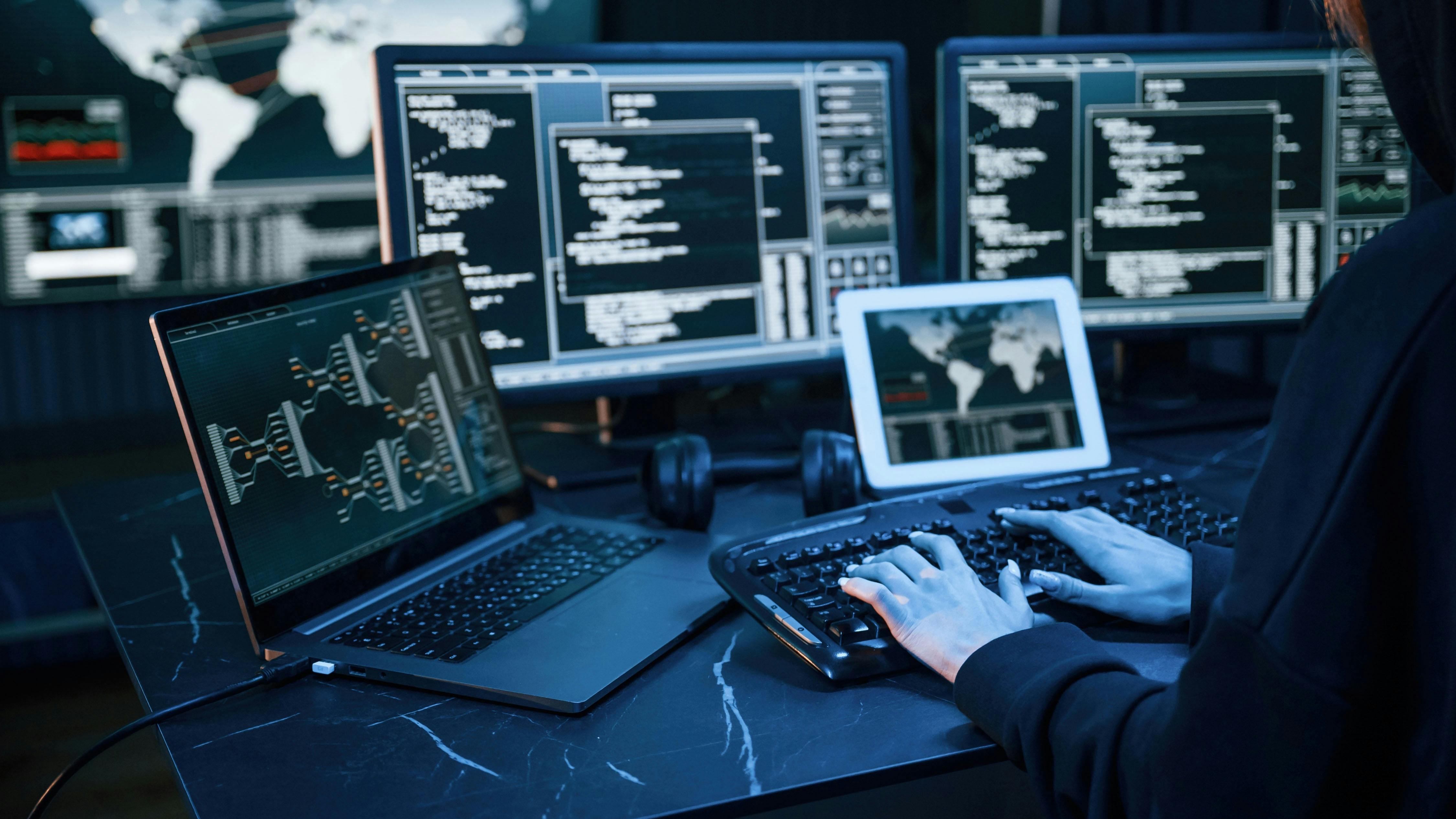 Young professional female with a lot of information on multiple screens.