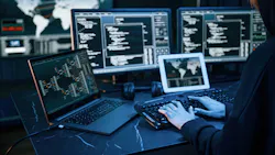 Young professional female with a lot of information on multiple screens.
