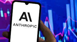 Logo of Anthropic AI on a smartphone screen with stock charts in the background.