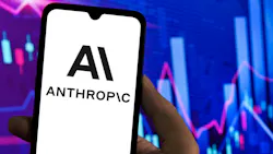 Logo of Anthropic AI on a smartphone screen with stock charts in the background.